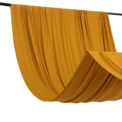 Mustard yellow fabric drapery on a black rod