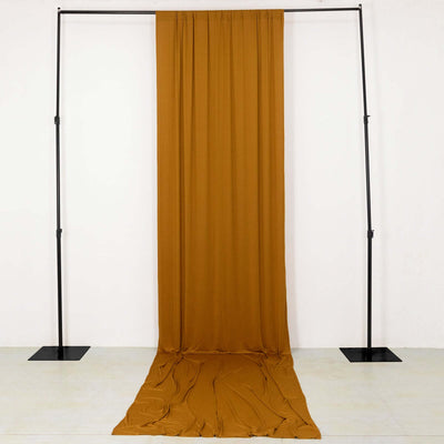 Brown fabric draped on a black metal frame backdrop