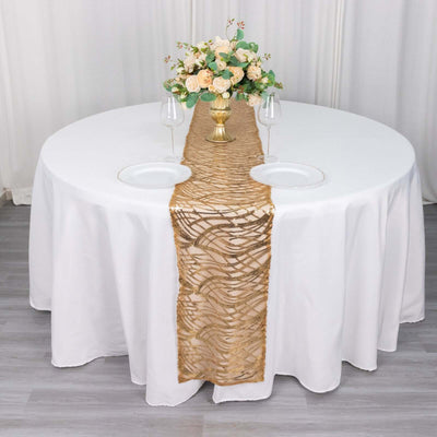 Elegant gold table runner on a round table with floral centerpiece and glassware.
