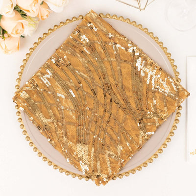 Gold sequined table napkin on a decorative plate.