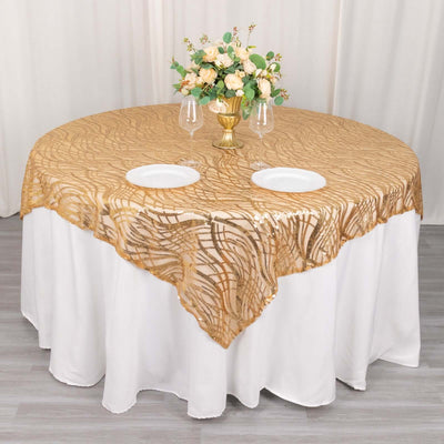 Elegant gold tablecloth with intricate design on round table setting.