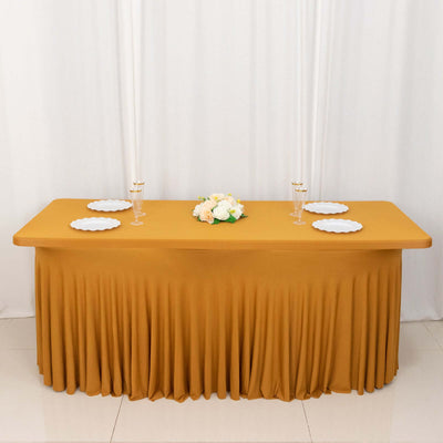 Elegant mustard tablecloth with decorative plates and floral centerpiece.