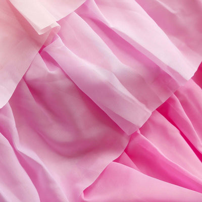 Pink layered tulle fabric with soft texture and flowing drapes.