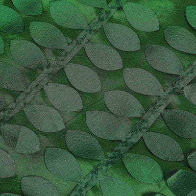 Green leaf-patterned fabric with a textured design.