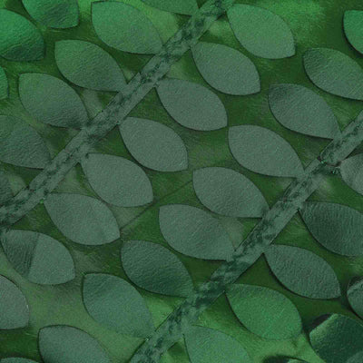 Green leaf pattern fabric texture close-up shot.