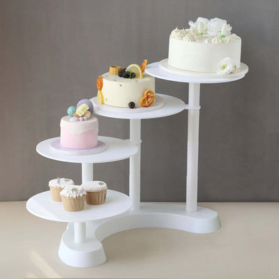 Decorative cake stand displaying various cakes and cupcakes in a staged setting.