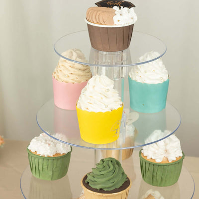 Colorful cupcake display on a tiered stand with various frosting styles.