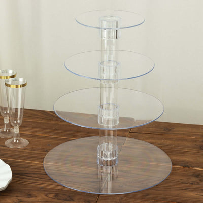 Clear acrylic three-tier serving stand on a wooden table.