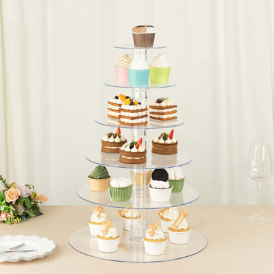 Cupcake display stand with assorted cupcakes on clear tiers.