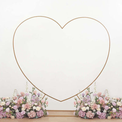 Heart-shaped photo backdrop with floral arrangements.