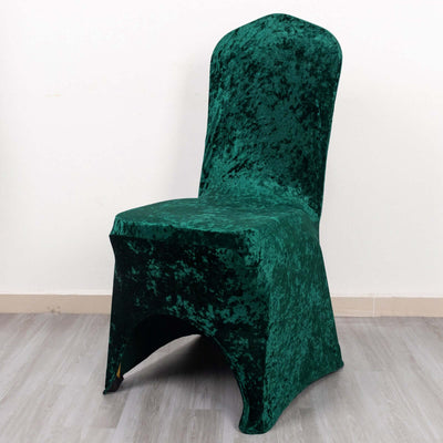 Green velvet chair cover on a plain background.