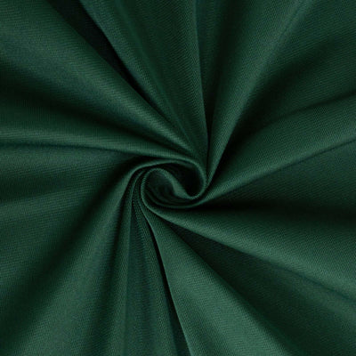 Green fabric texture in a spiral pattern.