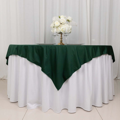 Elegant green and white table setup with floral centerpiece.