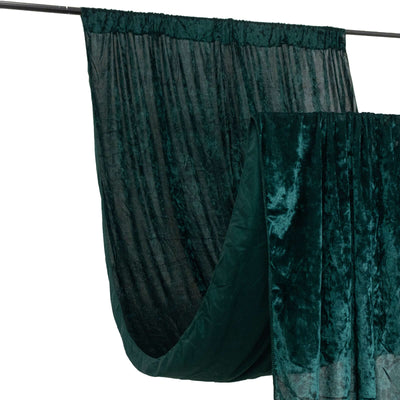 Velvet curtain in deep green hanging on a rod