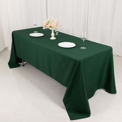 Elegant green tablecloth draped over a table set for dining.