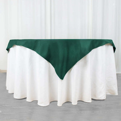 Green tablecloth draped over a white table