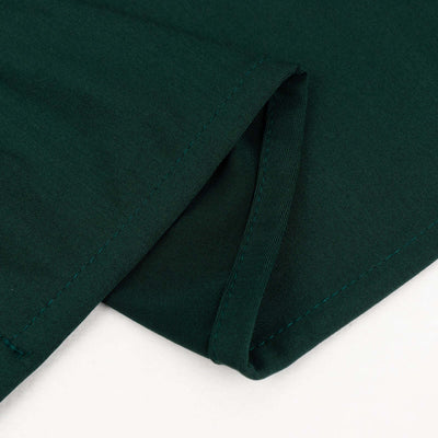 Close-up of dark green fabric with visible stitching details.