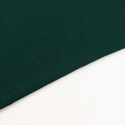 Dark green fabric corner with neat stitching detail.