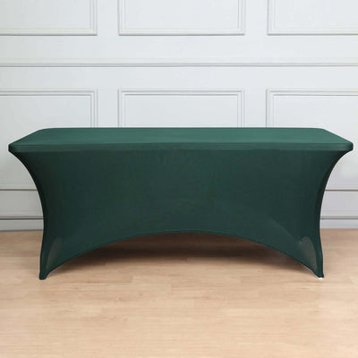 Green fitted table cover on a plain backdrop.