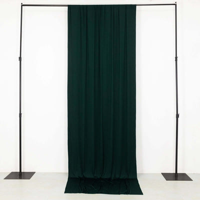 Dark green fabric draped on a stand against a plain backdrop.