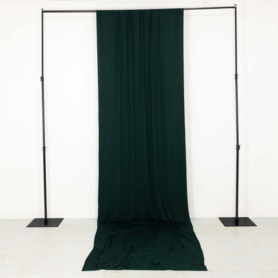 Dark green fabric backdrop on a support frame for photography or staging purposes.