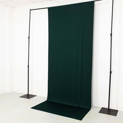 Green fabric backdrop on a stand for photography purposes