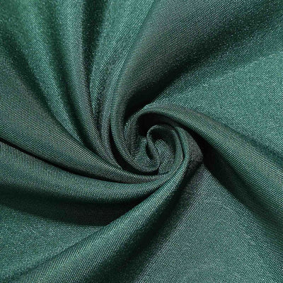 Green textured fabric swirl close-up shot.