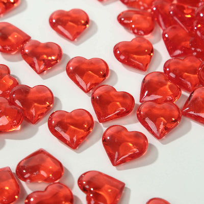 Red heart-shaped gems scattered on a white background.