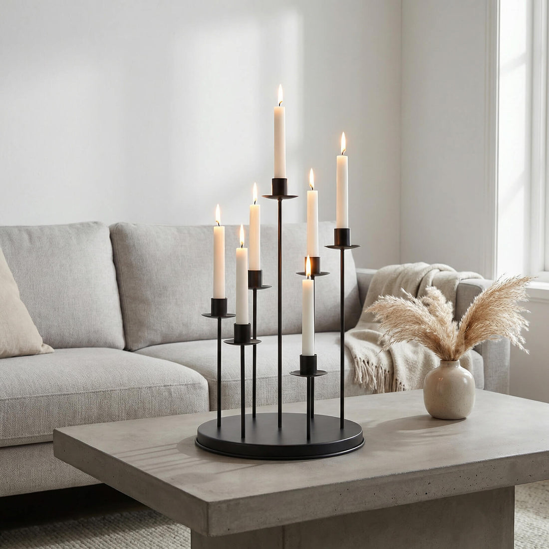 Modern living room with lit candles on a black candelabra centerpiece