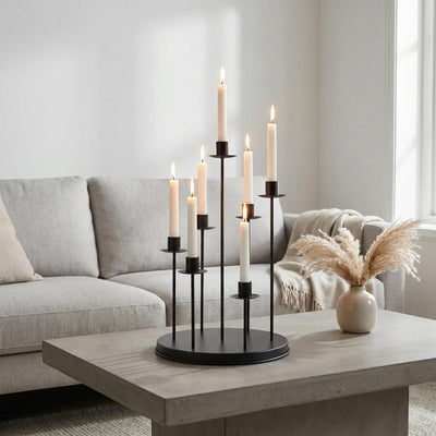 Modern living room with lit candles on a black candelabra centerpiece
