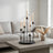 Modern living room with lit candles on a black candelabra centerpiece