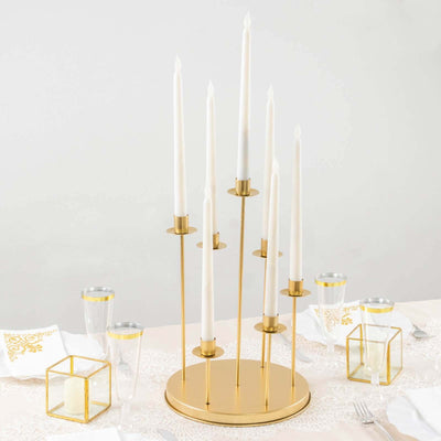 Gold candle holder with white candles, perfect for elegant table settings.