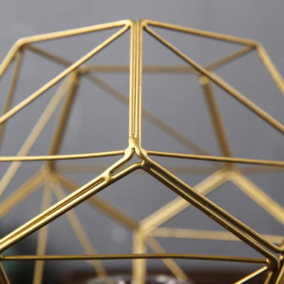 Gold geometric decor piece showcasing intricate metalwork details.