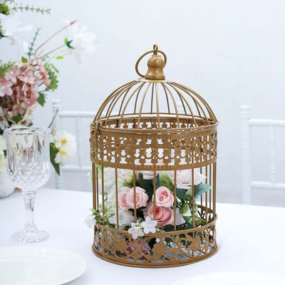 Gold metal birdcage centerpiece with pink roses and white flowers