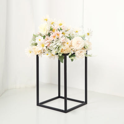 Floral arrangement with daisies and peonies in a black metal stand