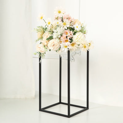 Floral arrangement in a black metal stand on a white background