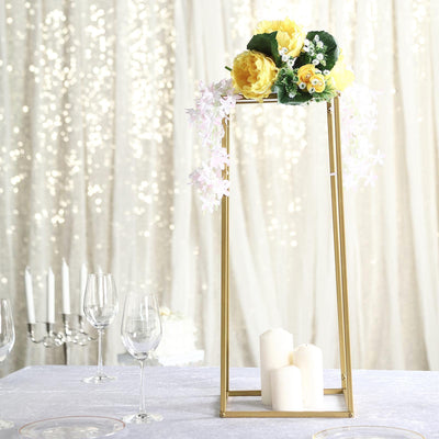 Gold candle holder with floral arrangement for elegant table decor.