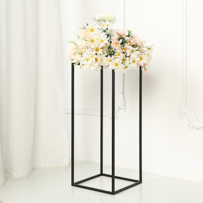 Modern black flower stand with a bouquet of daisies and pink flowers.