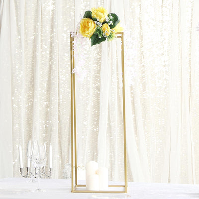 Gold floral centerpiece with yellow roses and white accents on a table.