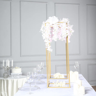 Elegant floral centerpiece with gold frame for weddings or events.