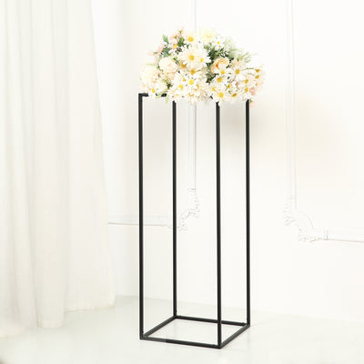 Flower arrangement in minimalist black metal stand on a white background