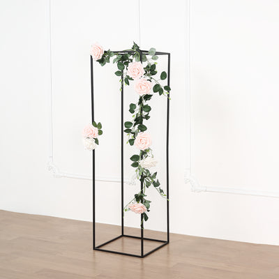 Flower stand with pink and white roses on a black frame.