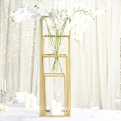Elegant gold flower vase with white orchids for table decoration.