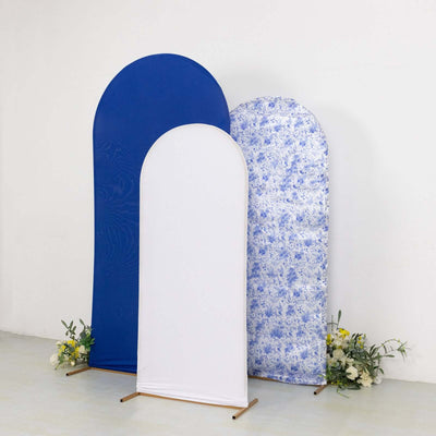Three fabric backdrops in blue, white, and floral patterns on stands.