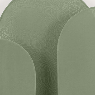 Green fabric texture in abstract shapes against a plain backdrop.