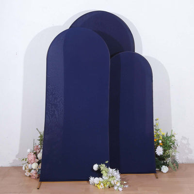 Navy blue fabric backdrops in various sizes with floral arrangement at the base.
