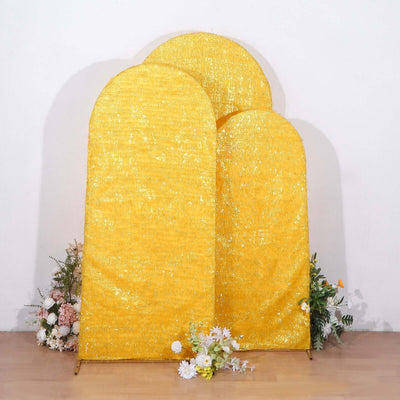 Three arched yellow backdrops with floral accents.