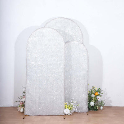 Decorative silver screens with floral accents against a plain backdrop.