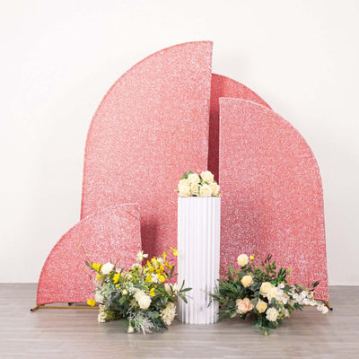 Pink glitter backdrop with flowers in a white vase for event decor.