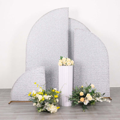 Decorative silver backdrop with flowers in a white vase.